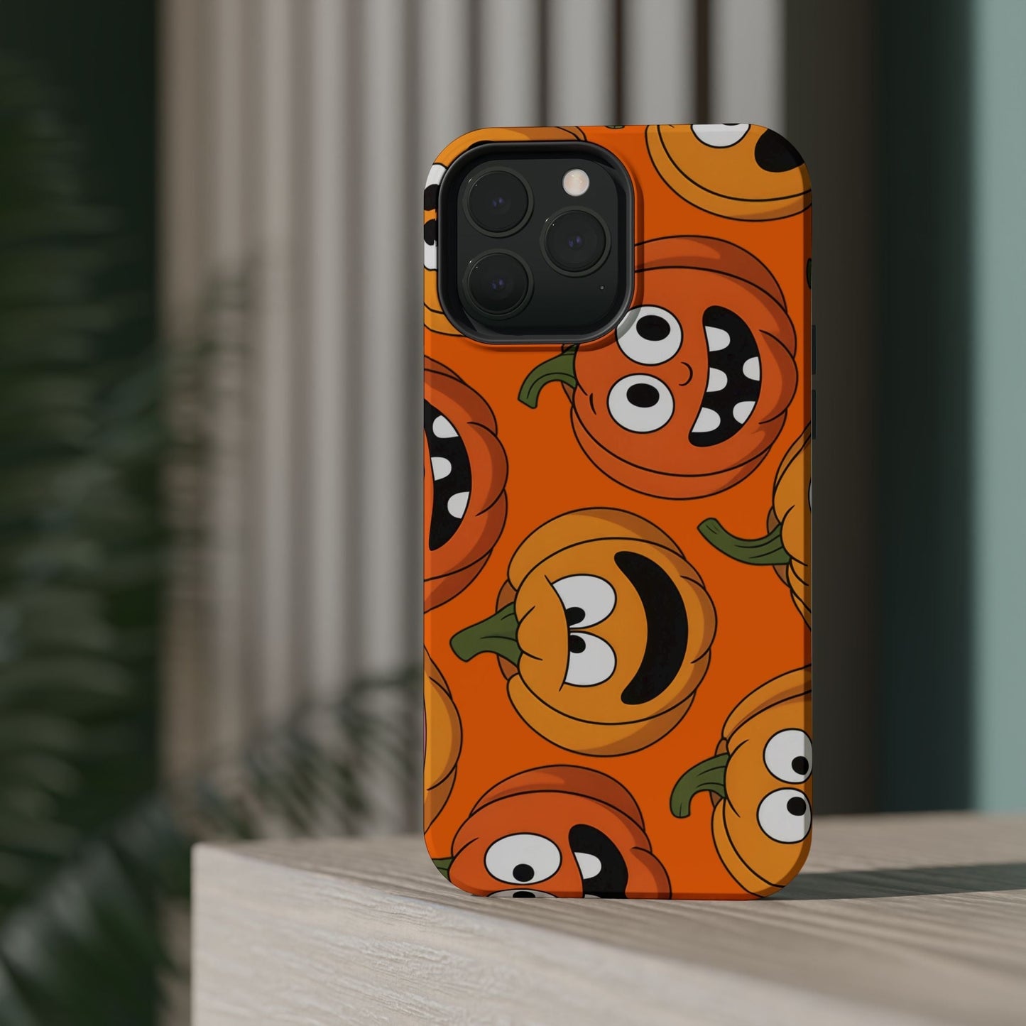 iPhone case with moody pumpkins design in vibrant orange, durable protective polycarbonate and TPU, MagSafe compatible Halloween phone cover