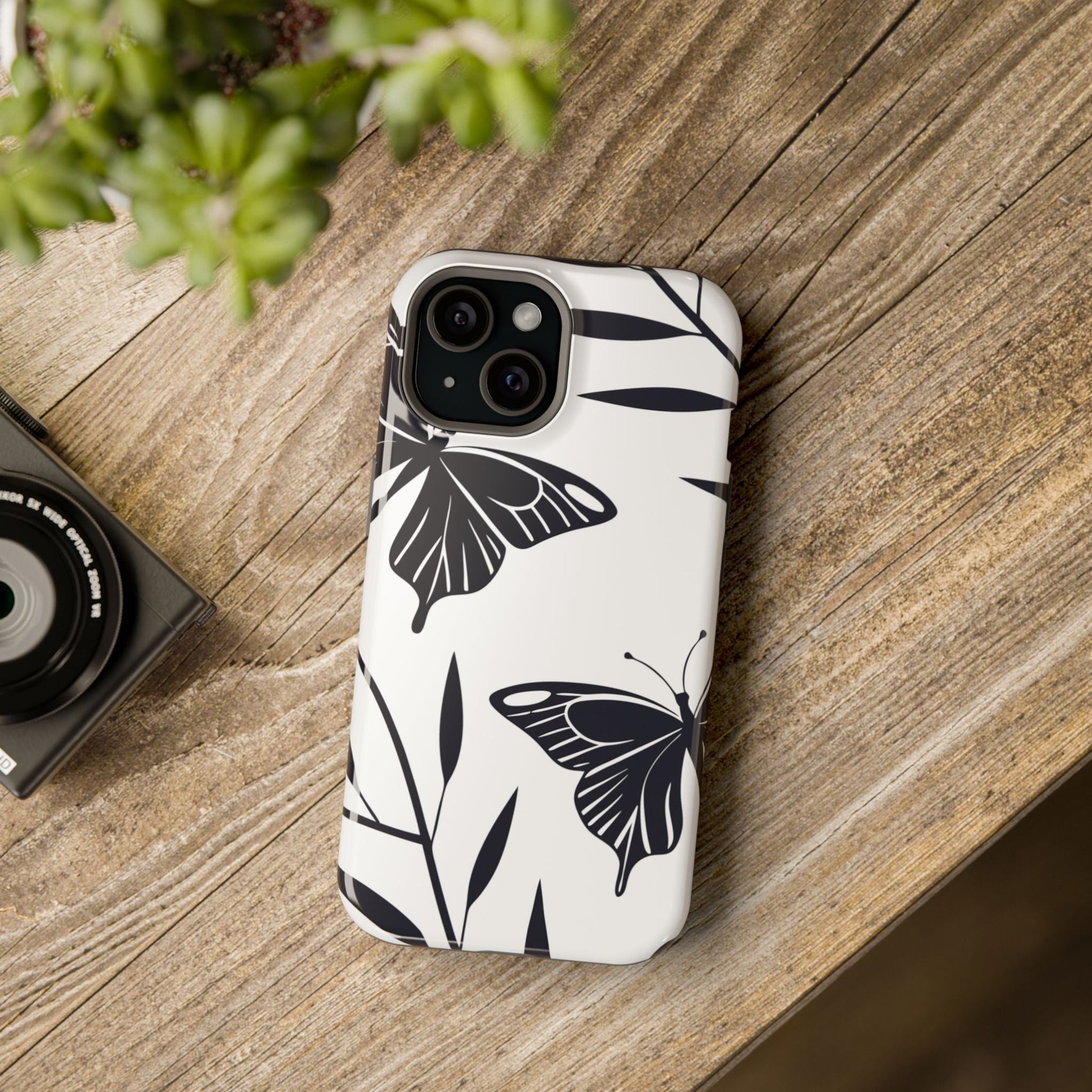 Black and white minimalist butterfly design iPhone case with MagSafe compatibility and protective dual-layer construction