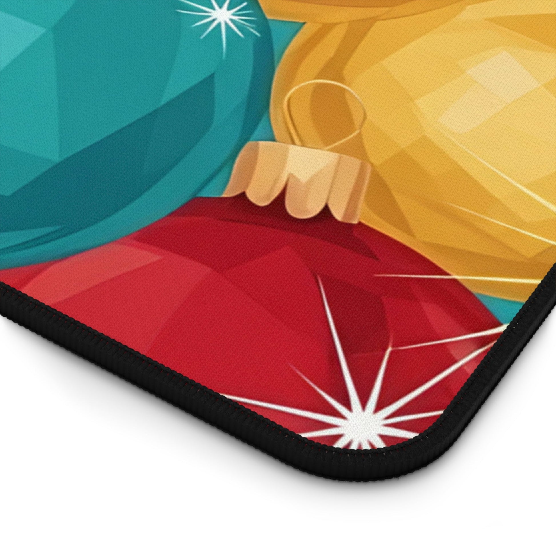 Close-up of holiday-themed desk mat featuring colorful Christmas tree bulb ornaments with non-slip black hemmed edge