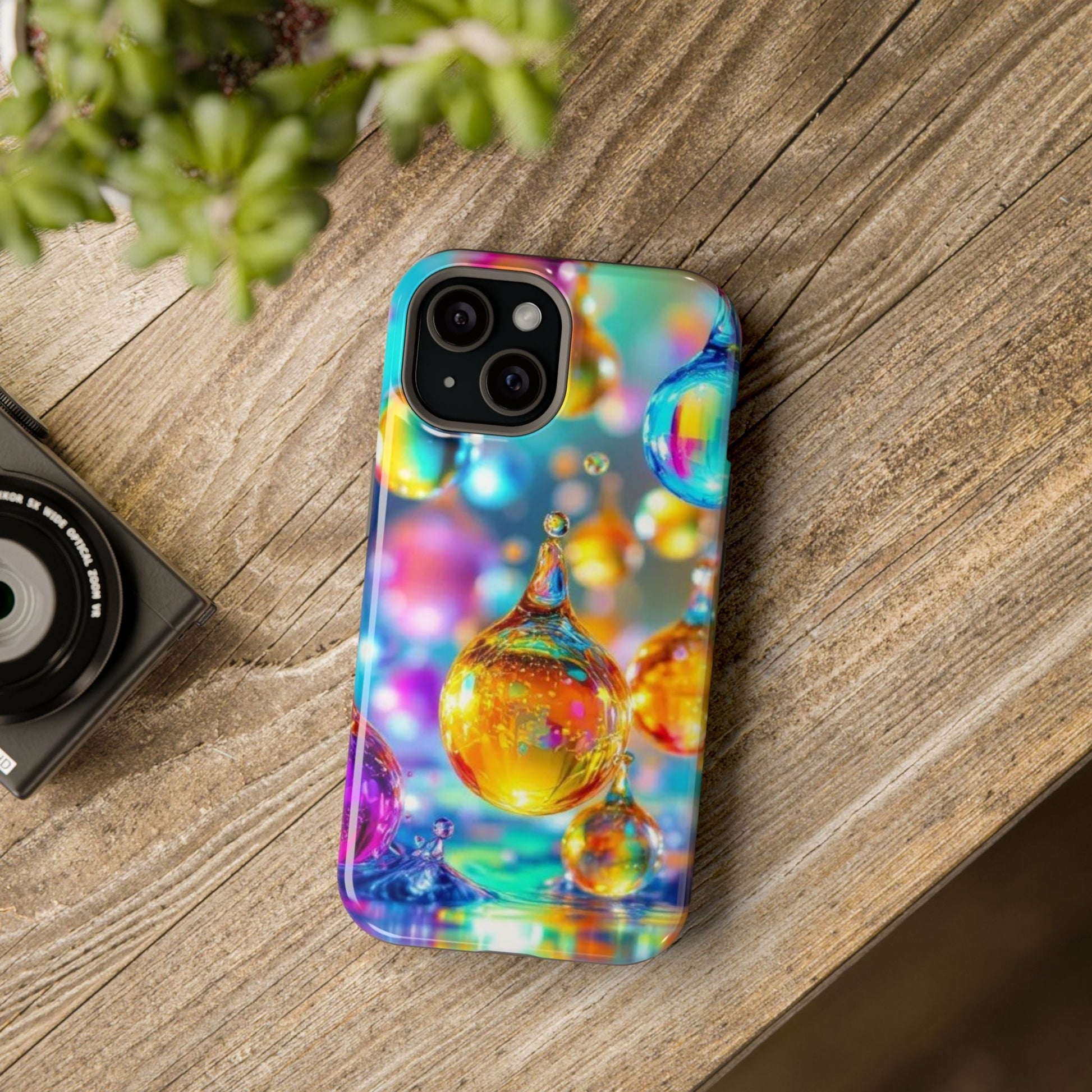 Golden Raindrop Design iPhone tough case with vibrant colorful raindrop pattern and MagSafe compatibility on wooden surface