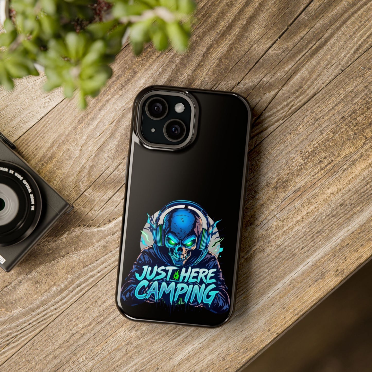 iPhone tough case with Just Here Camping Gamer design featuring a skull with headphones and vibrant colors