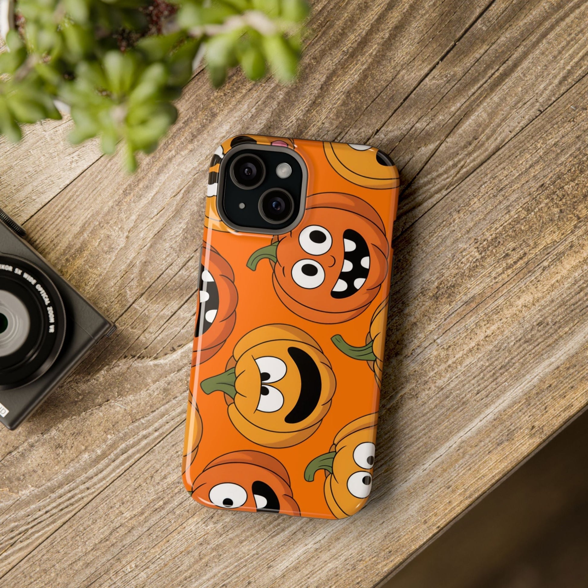 iPhone case with Moody Pumpkins Design featuring vibrant orange spooky pumpkin faces and durable protective build