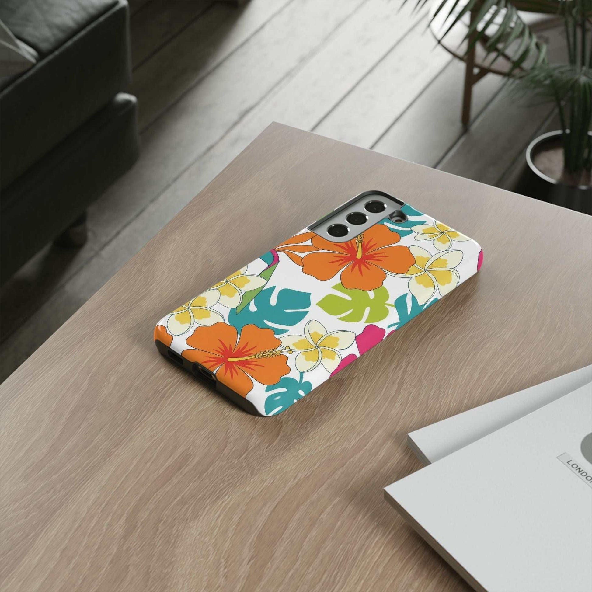 Orange floral Samsung case with vibrant tropical flower design on wooden table