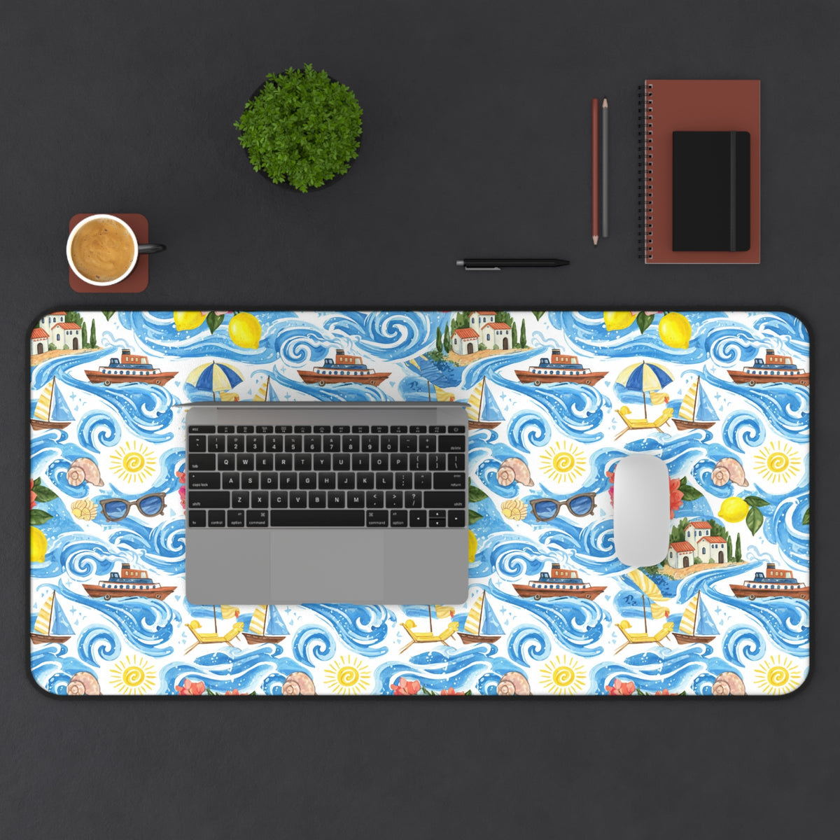 Desk mat with a watercolor print of boats, sunny skies, lemons, and coastal houses.