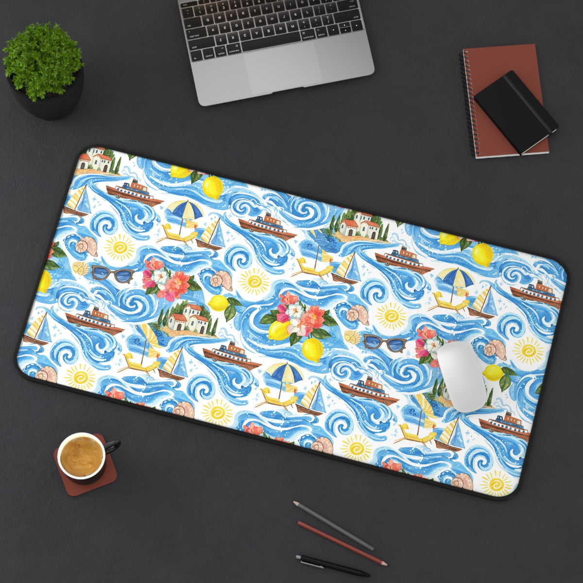 Desk mat with a watercolor seaside pattern featuring boats, lemons, and houses.
