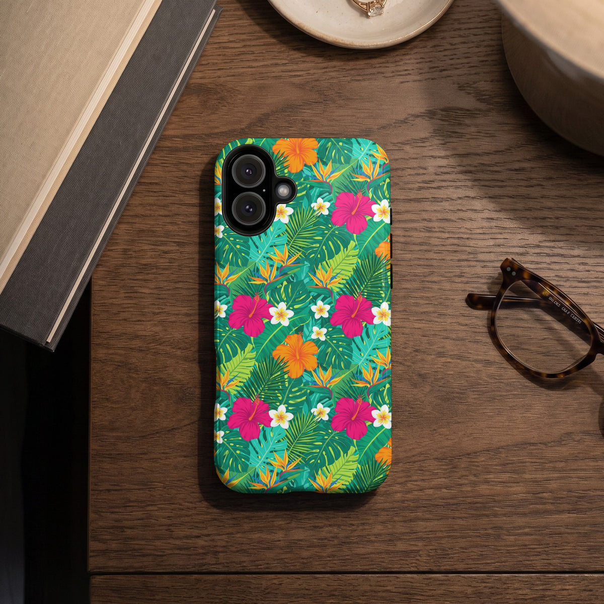Phone case with a vibrant green tropical floral and leaf pattern.