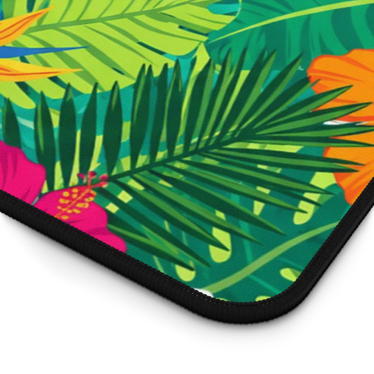 Tropical leaves and flowers in vibrant green, pink, orange, and yellow on a mousepad.