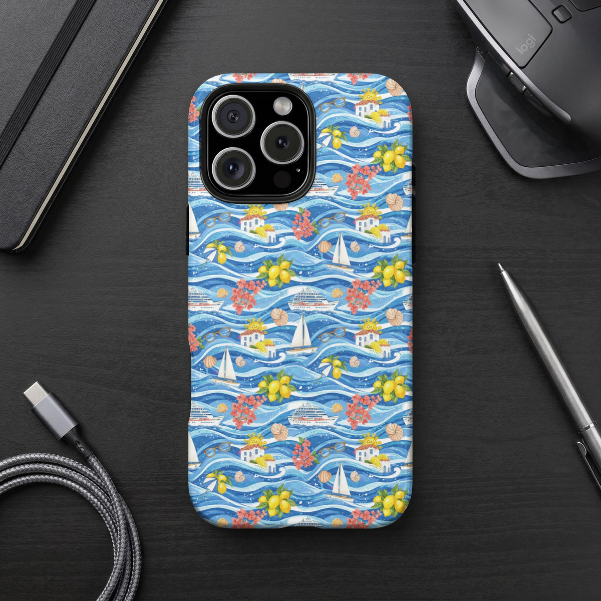 Phone case with a nautical pattern of boats, houses, lemons, and flowers on a blue wavy background.
